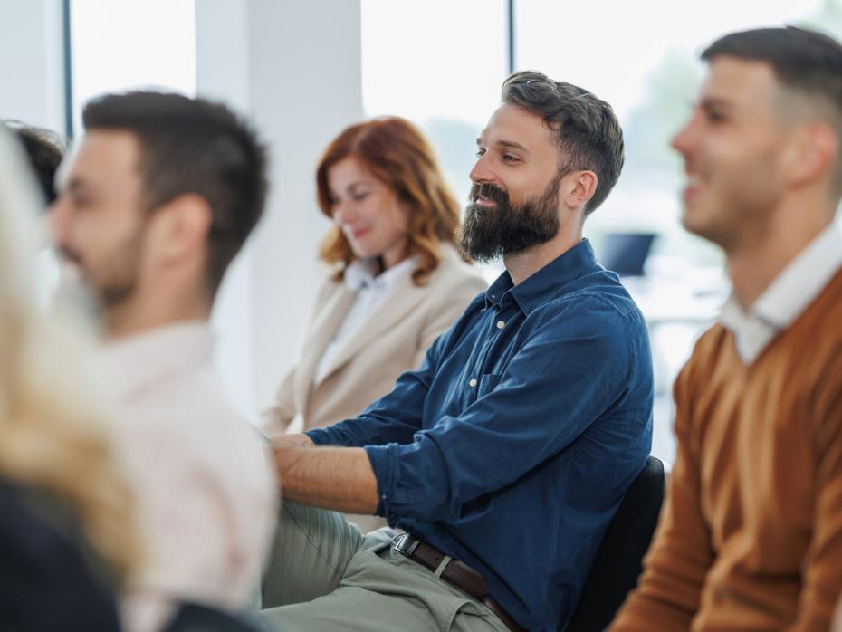 Academics watching an unseen speaker