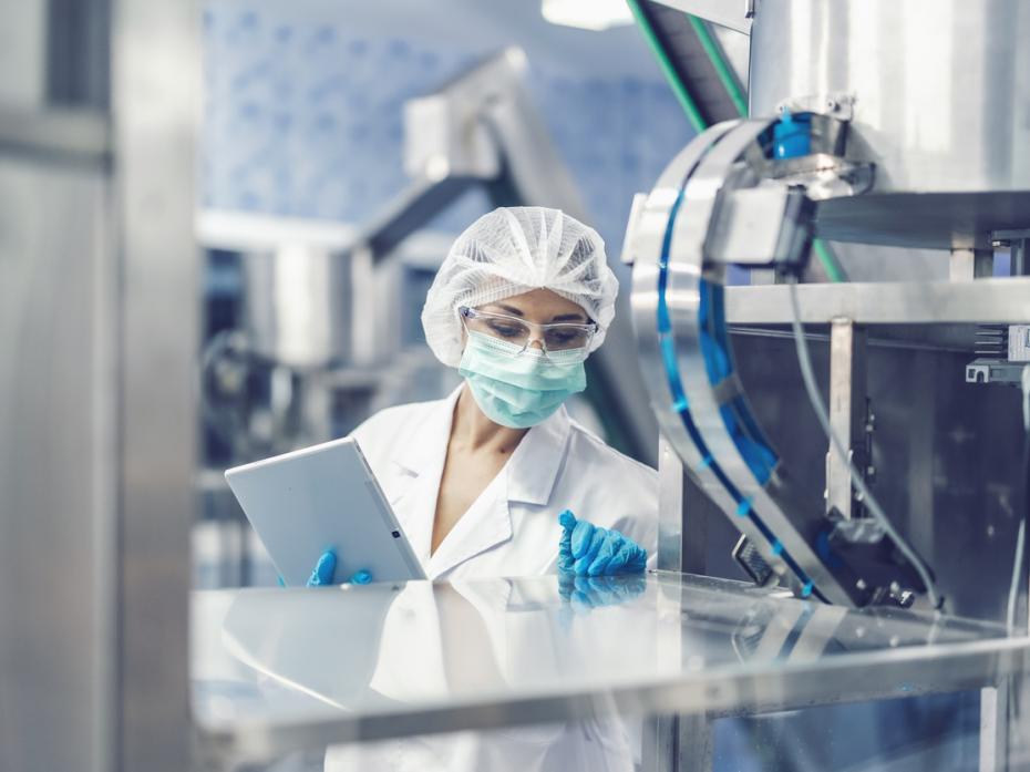 A pharmaceutical machine inspector at work in science laboratory