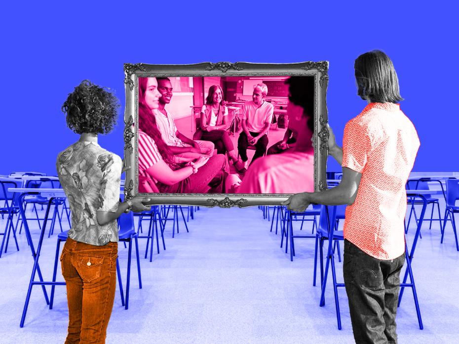 People hold up a picture frame to a classroom
