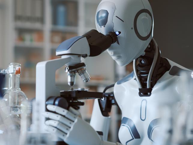 A robot uses a microscope in a laboratory