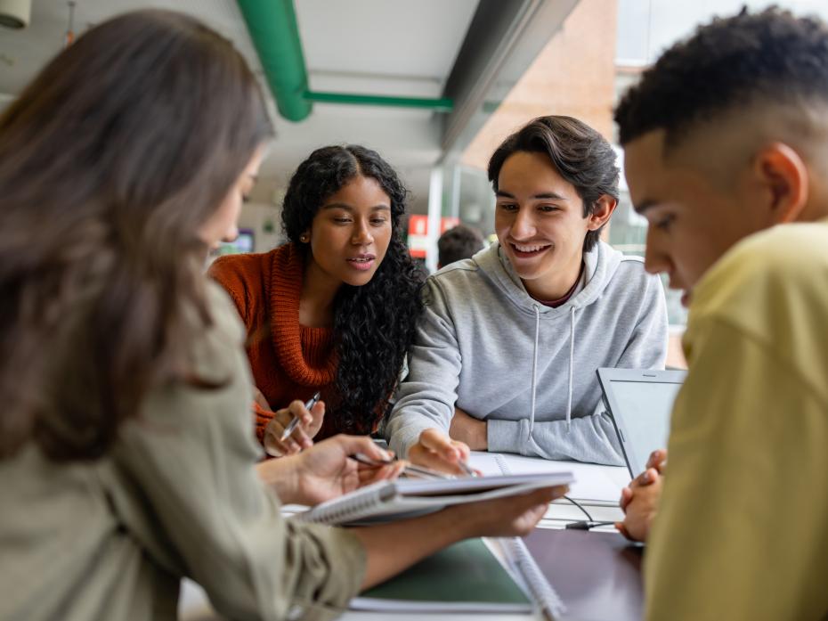 A group of students at a desk working on a project