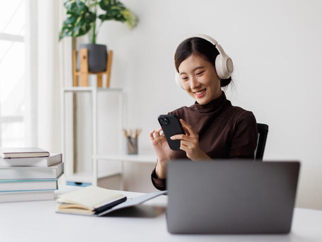 A student uses her phone while studying