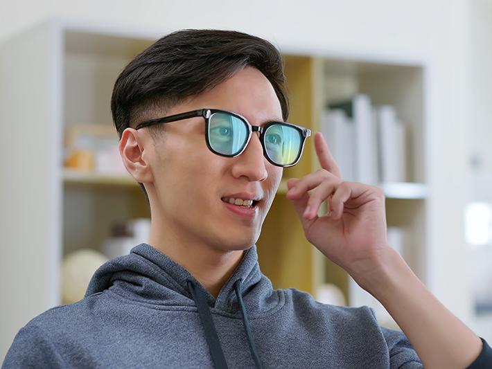 Asian man wearing AR glasses