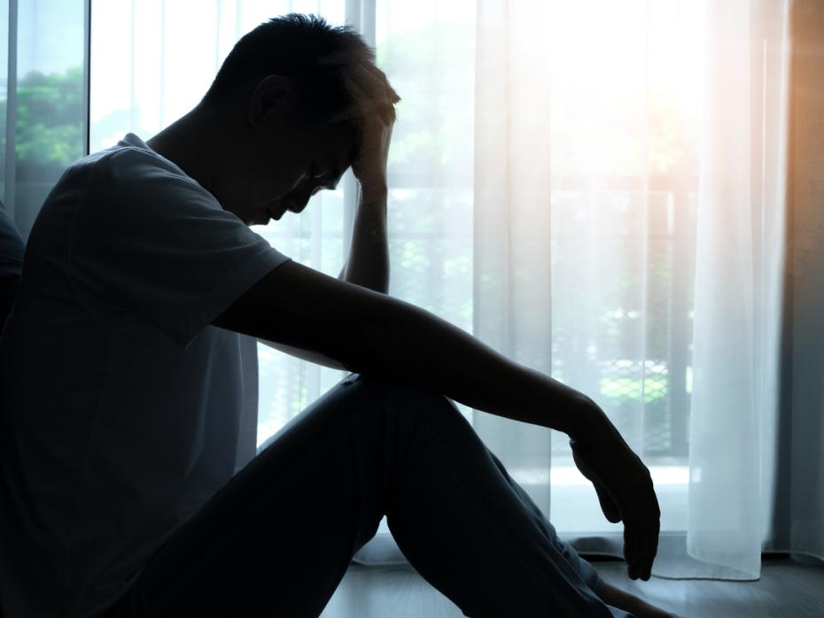Man sitting alone in a state of distress or worry