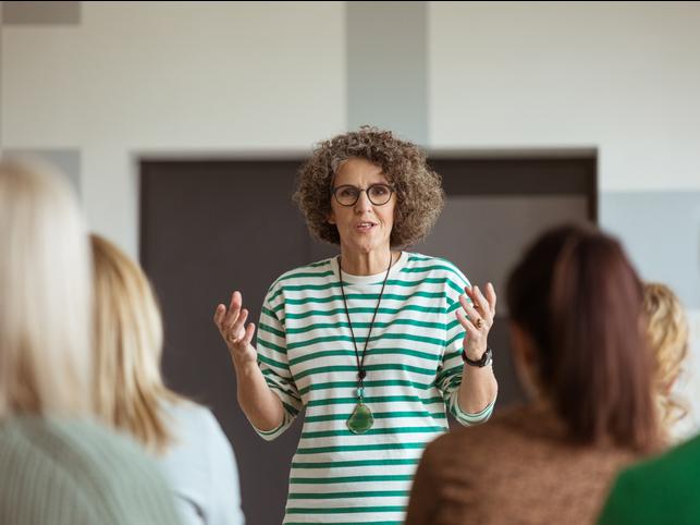 A teacher presenting to a class full of students