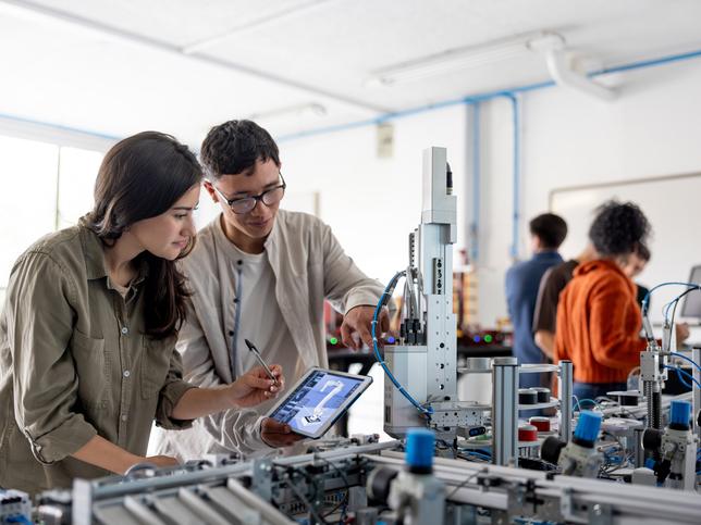 Researchers building a robotic arm