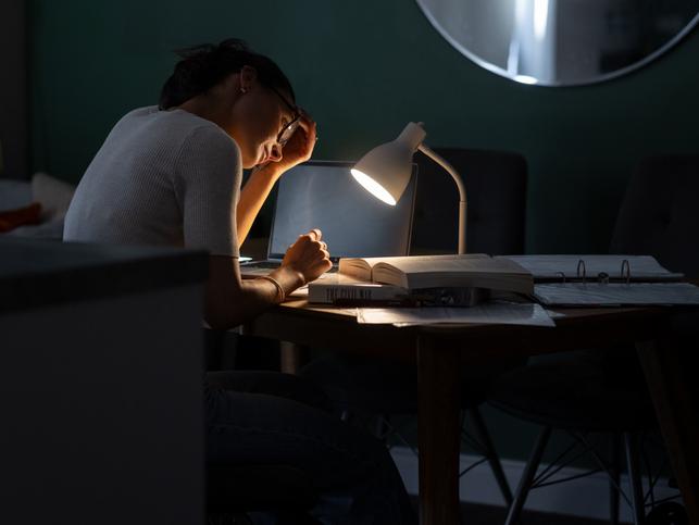 A woman works alone at a desk