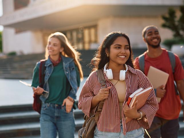 Students walk happily across campus