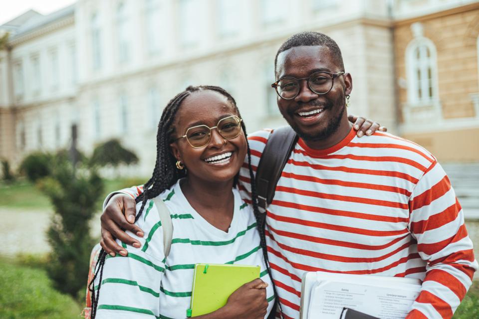 Two students smiling to camera