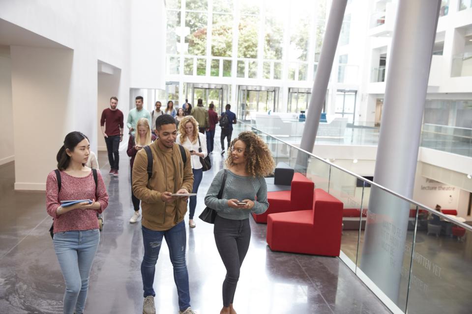 Students walking through campus building