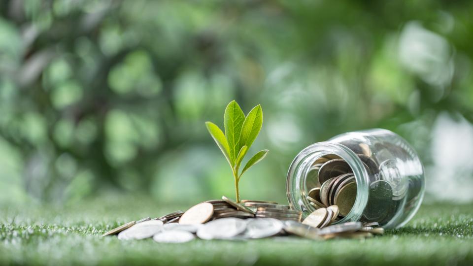 A jar with coins spilling uot of it