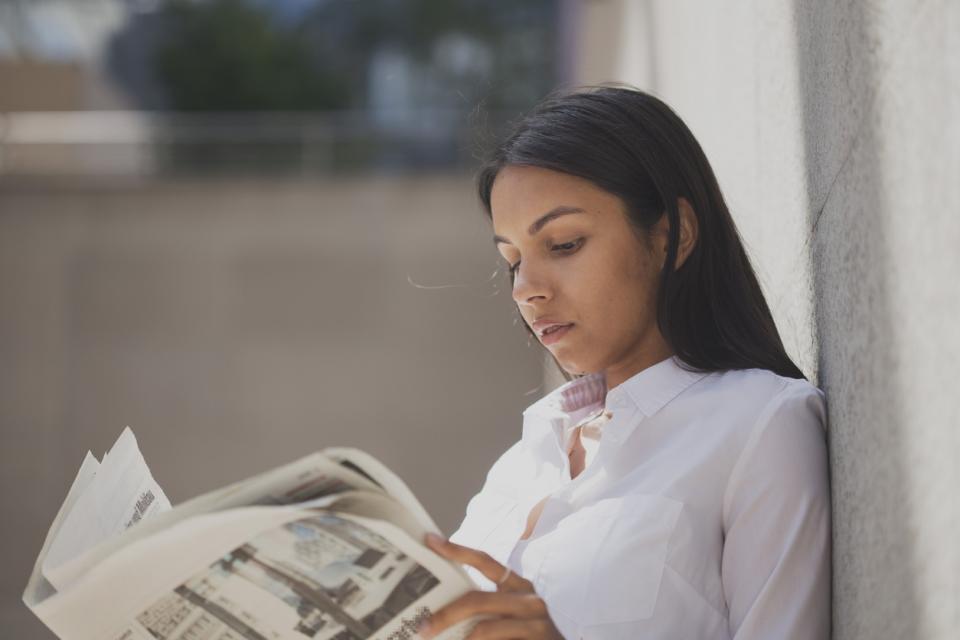 A student reading a newspaper