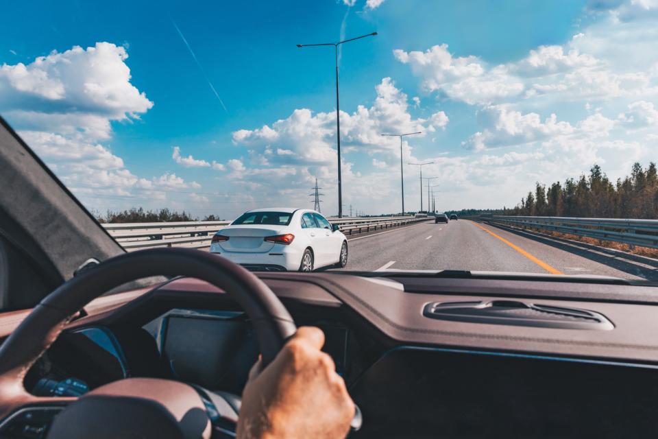 An unseen driver at the wheel of a car
