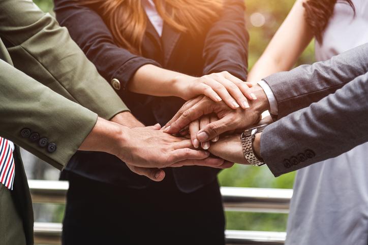 Business people clasp hands