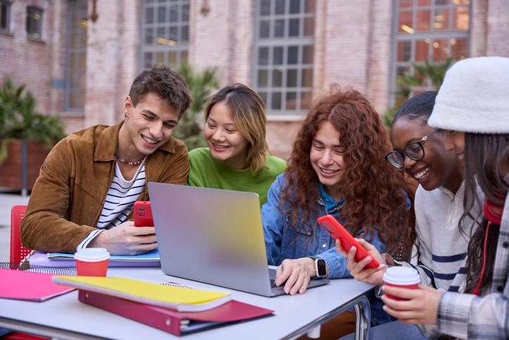 Students work together over a laptop