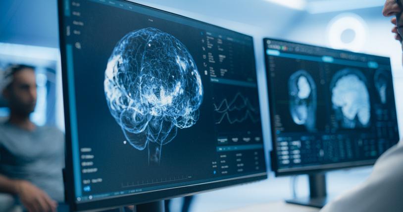 A scientist views a brain scan on a screen