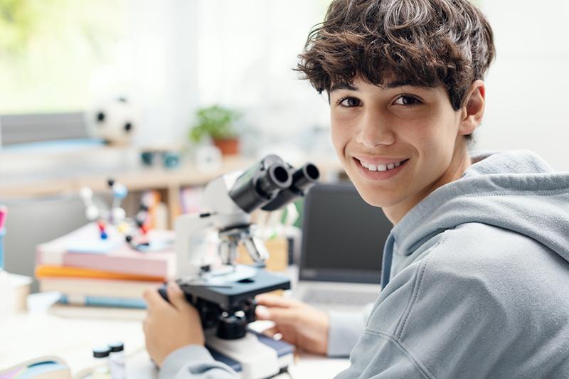 Teen boy in a science lab