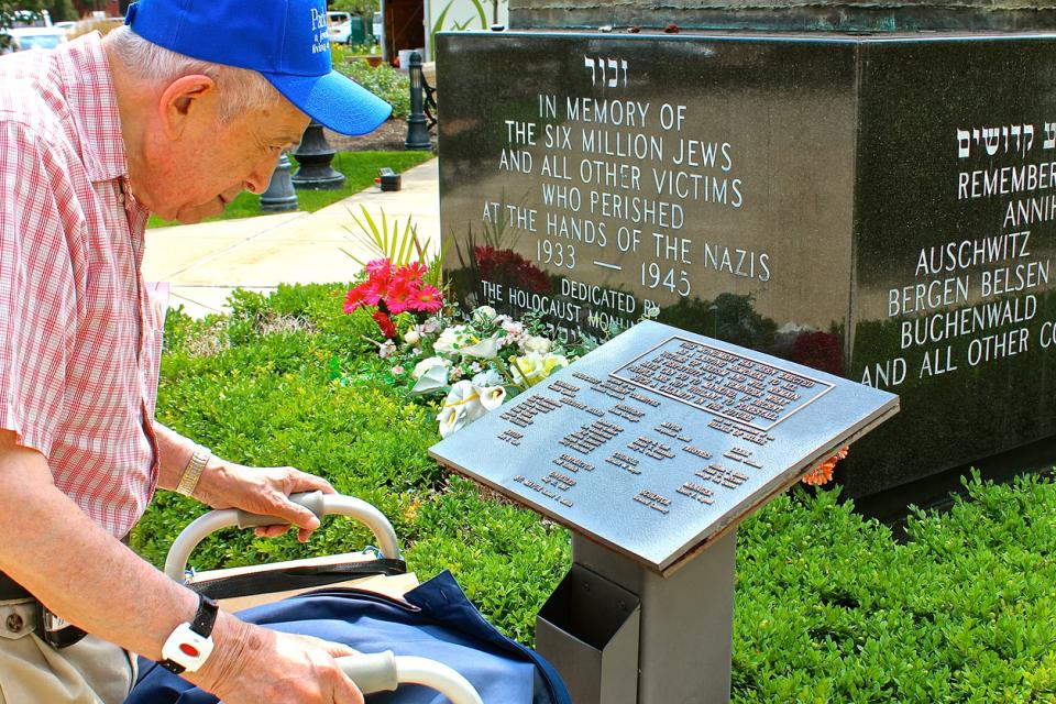 92 year-old Jewish Holocaust survivor, Larry Heimlich of Chicago, reading a dedication plaque at a Holocaust Monument