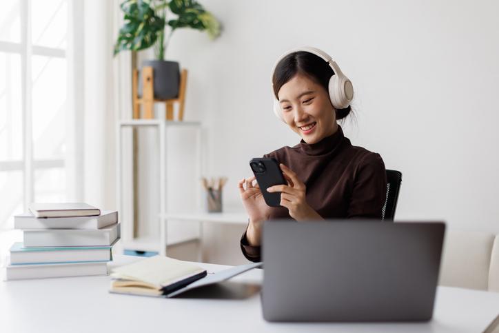 A student uses her phone while studying