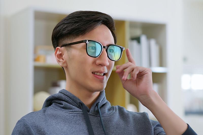 Asian man wearing AR glasses