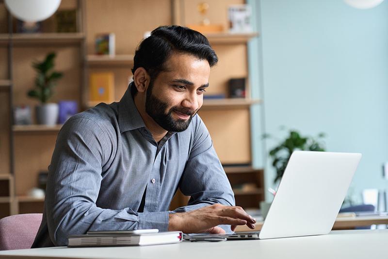 Young indian student using computer remote studying