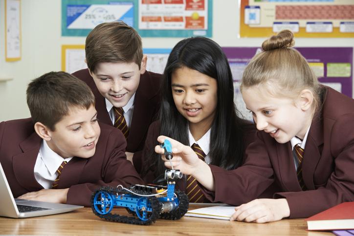 School children building a small robot