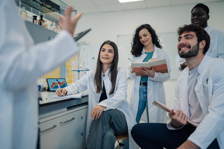 STEM students discuss ideas in a lab