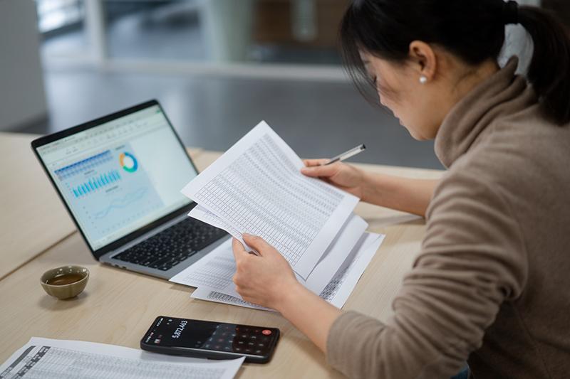 Asian female financial student doing calculations