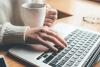 Woman working at laptop with coffee
