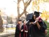 Two happy young students hugging each other on graduation day