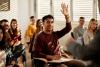 A student raises a hand in a classroom